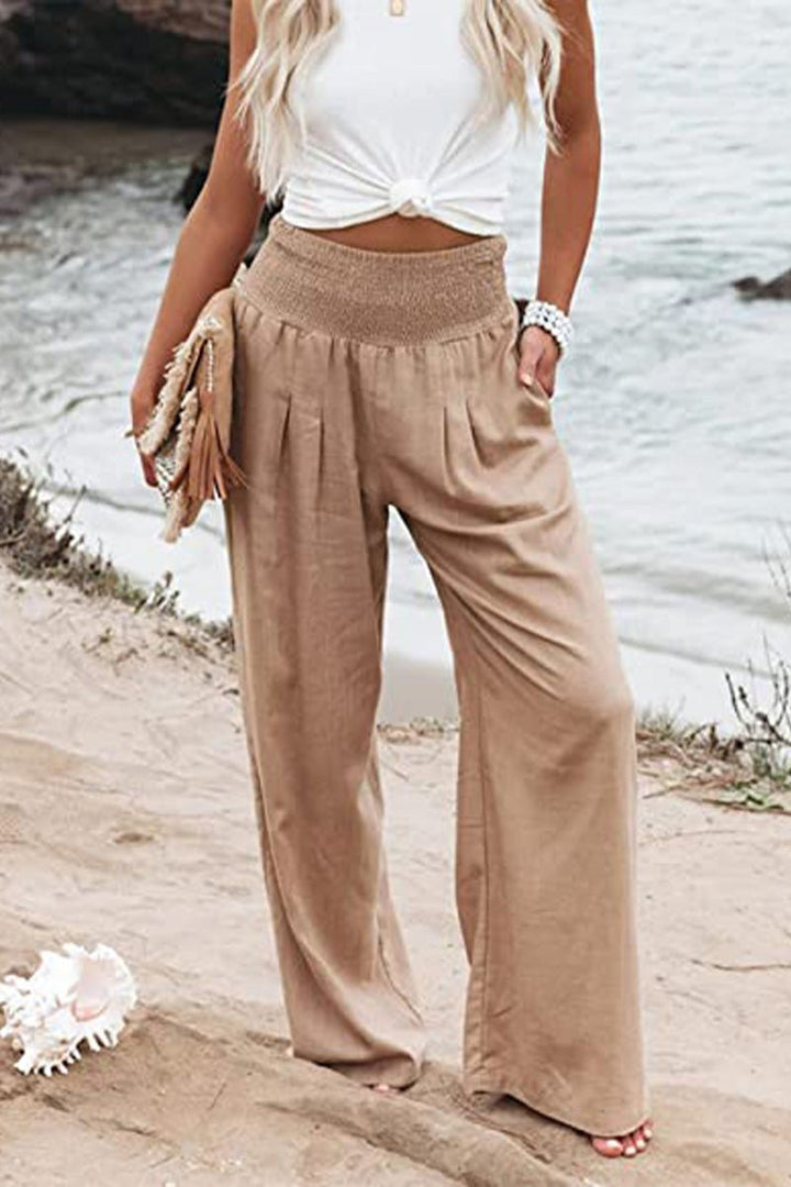 Women's high-waisted smocked wide-leg linen pants for a comfortable, flowing summer style.