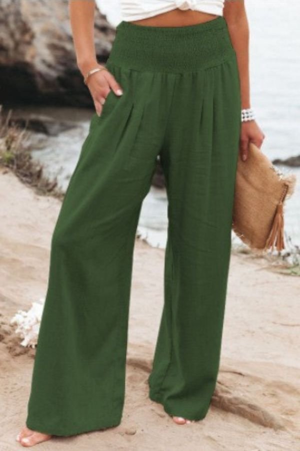 Ladies' high-rise smocked waist wide-leg linen trousers, offering a cool and flowing summer feel.