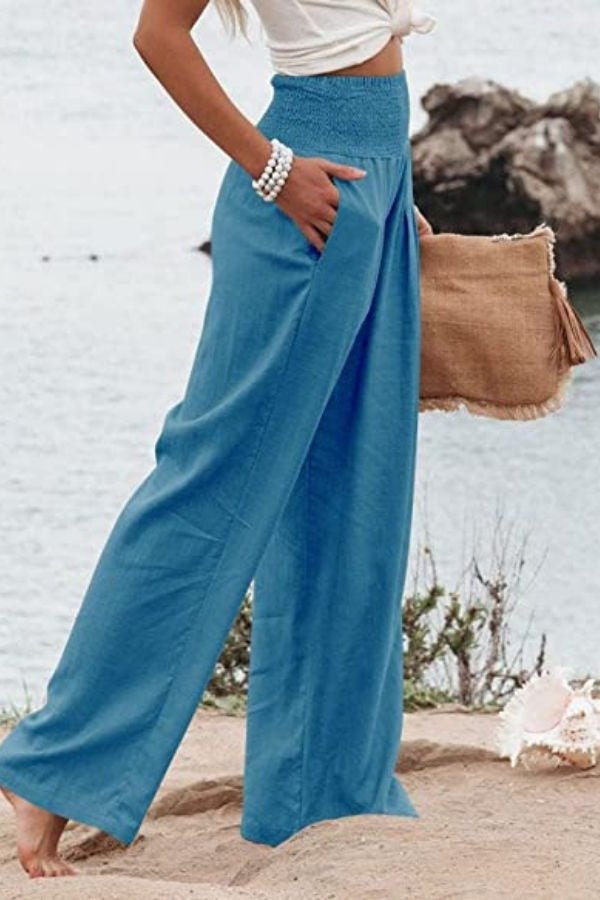 Breezy women's linen wide-leg pants with a high smocked waist, perfect for summer comfort & beach.