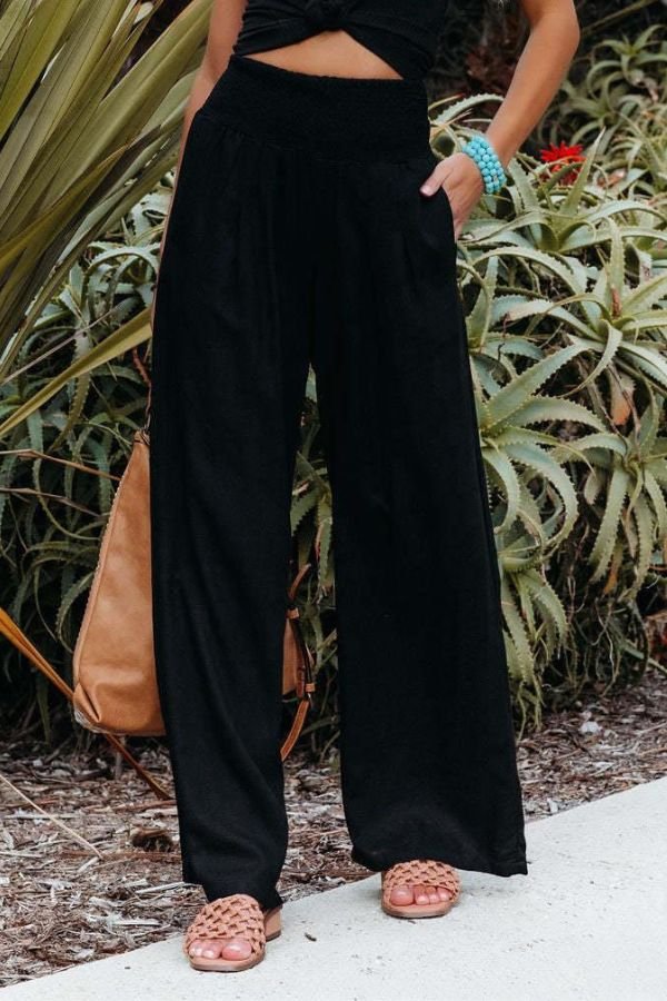 Stylish women's high-waisted smocked linen pants, designed with a flattering wide-leg and flowing fit.