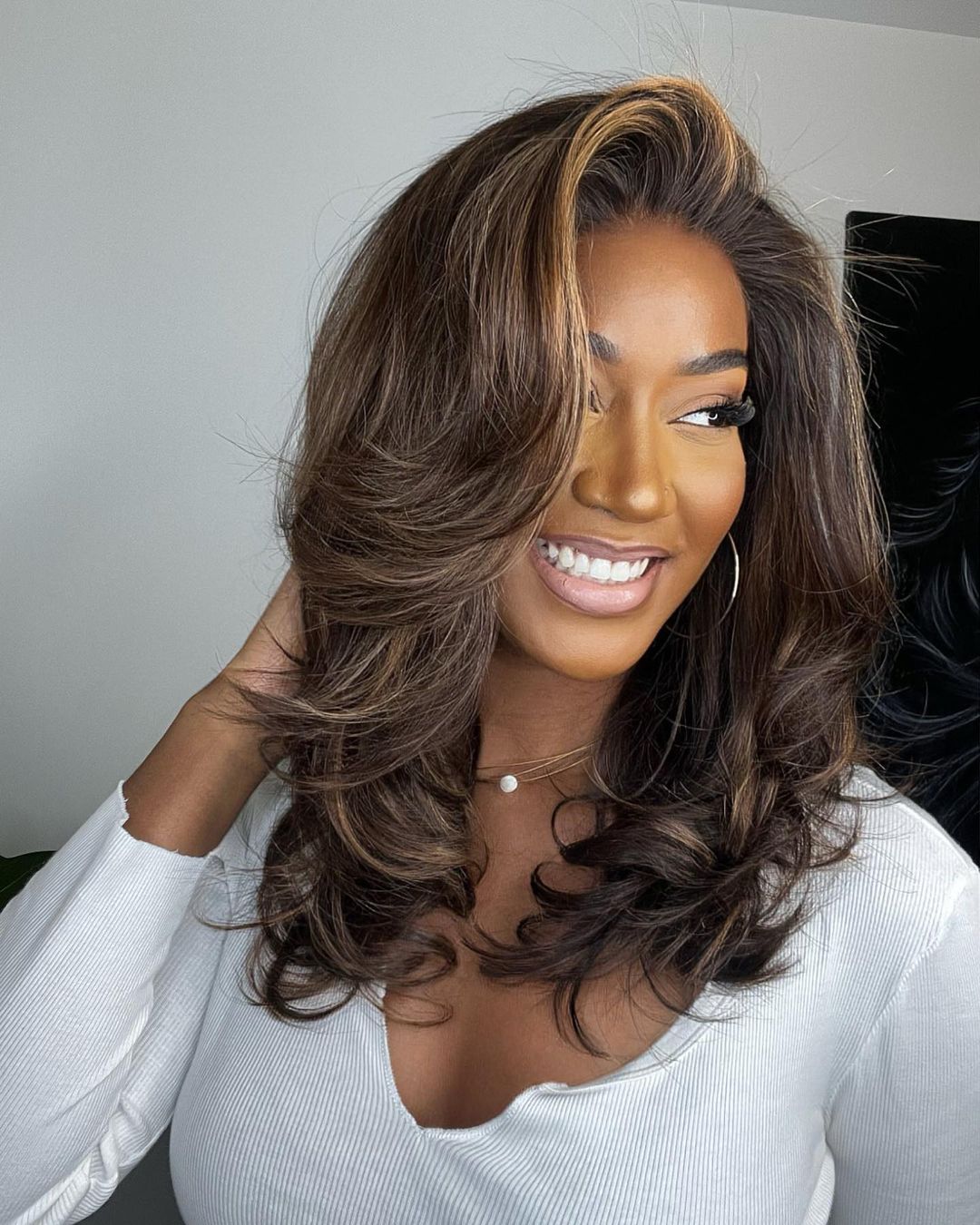 Natural wave virgin human hair lace front wig for women, dark brown with subtle blonde highlights.
