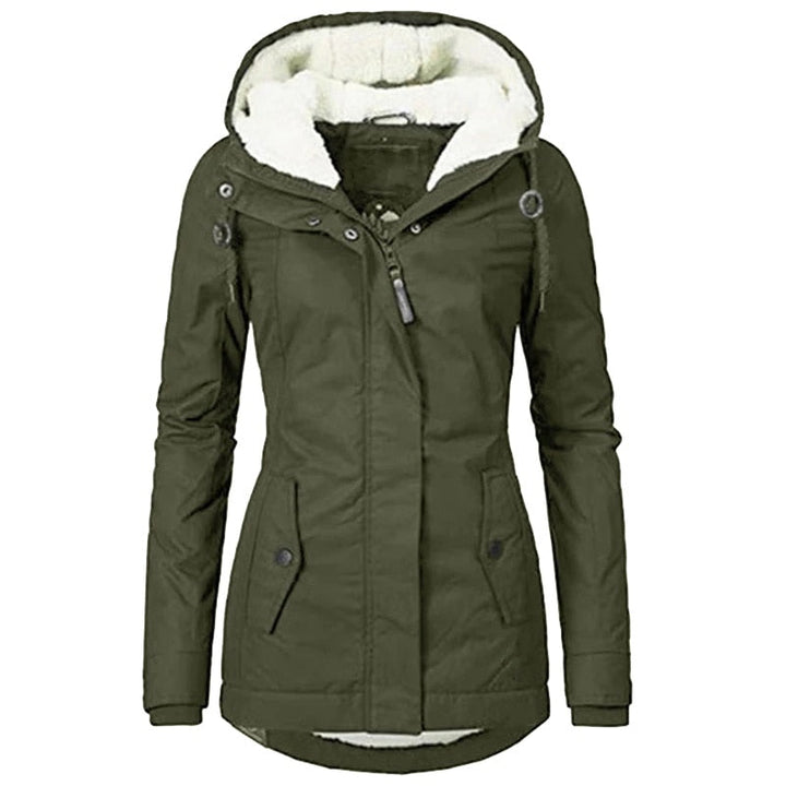 Fashion shot of woman wearing a stylish insulated fur-lined winter parka in urban setting.