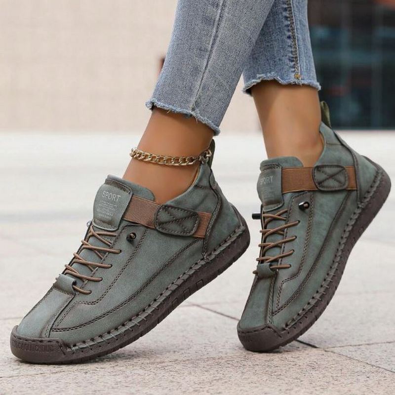 Women's chic lace-up flat sneakers. Features stylish decorative stitching, perfect for casual & everyday comfort.
