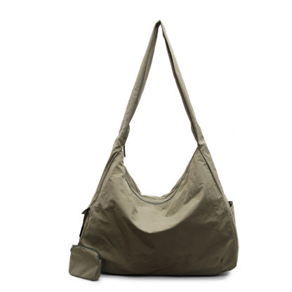 Women's large capacity casual crossbody bag shown in a lifestyle setting, perfect for daily errands.