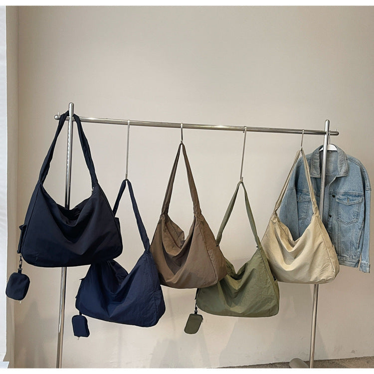Black women's casual shoulder bag, a versatile large capacity crossbody with an adjustable strap.