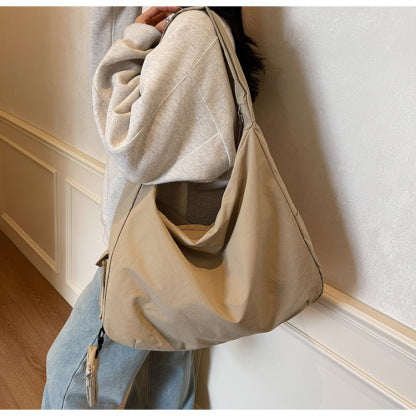 Coffee colored women's everyday crossbody bag, spacious and casual with an adjustable strap.