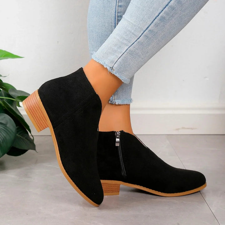 Fashion-forward women's leopard print boots with a sleek zipper, suitable for various occasions.