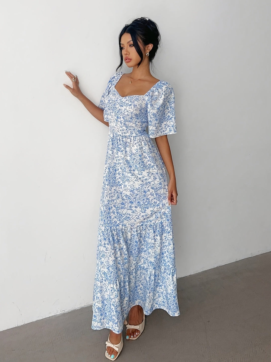 Chic women's floral tiered maxi dress with sweetheart neckline, an elegant pink summer dress perfect for special occasions.