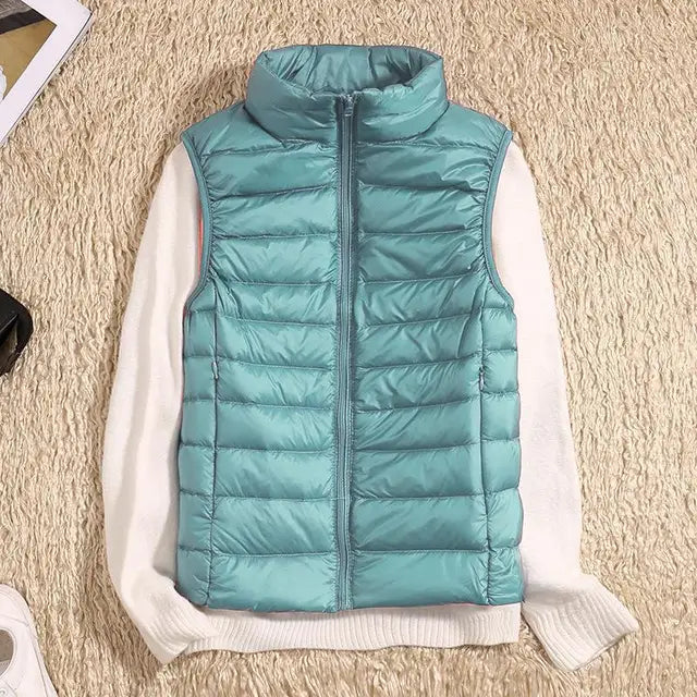 Close-up of the quilted texture and high collar on a women's lightweight puffer vest in plum