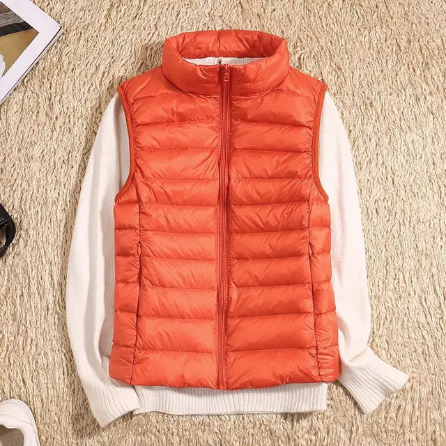 Lightweight women's puffer vest in olive green, featuring a high collar and quilted pattern, winter essential