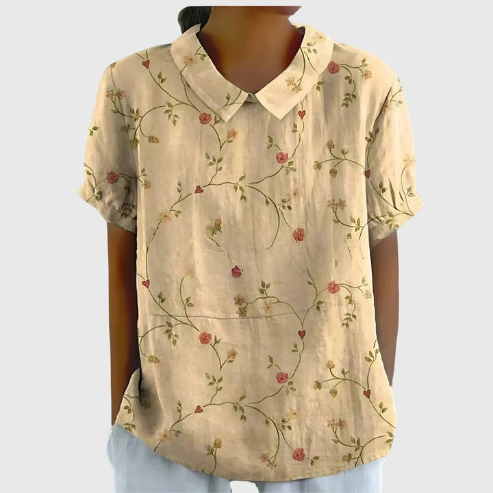 Close-up of lightweight fabric & vibrant floral pattern on a comfortable women's spring blouse.