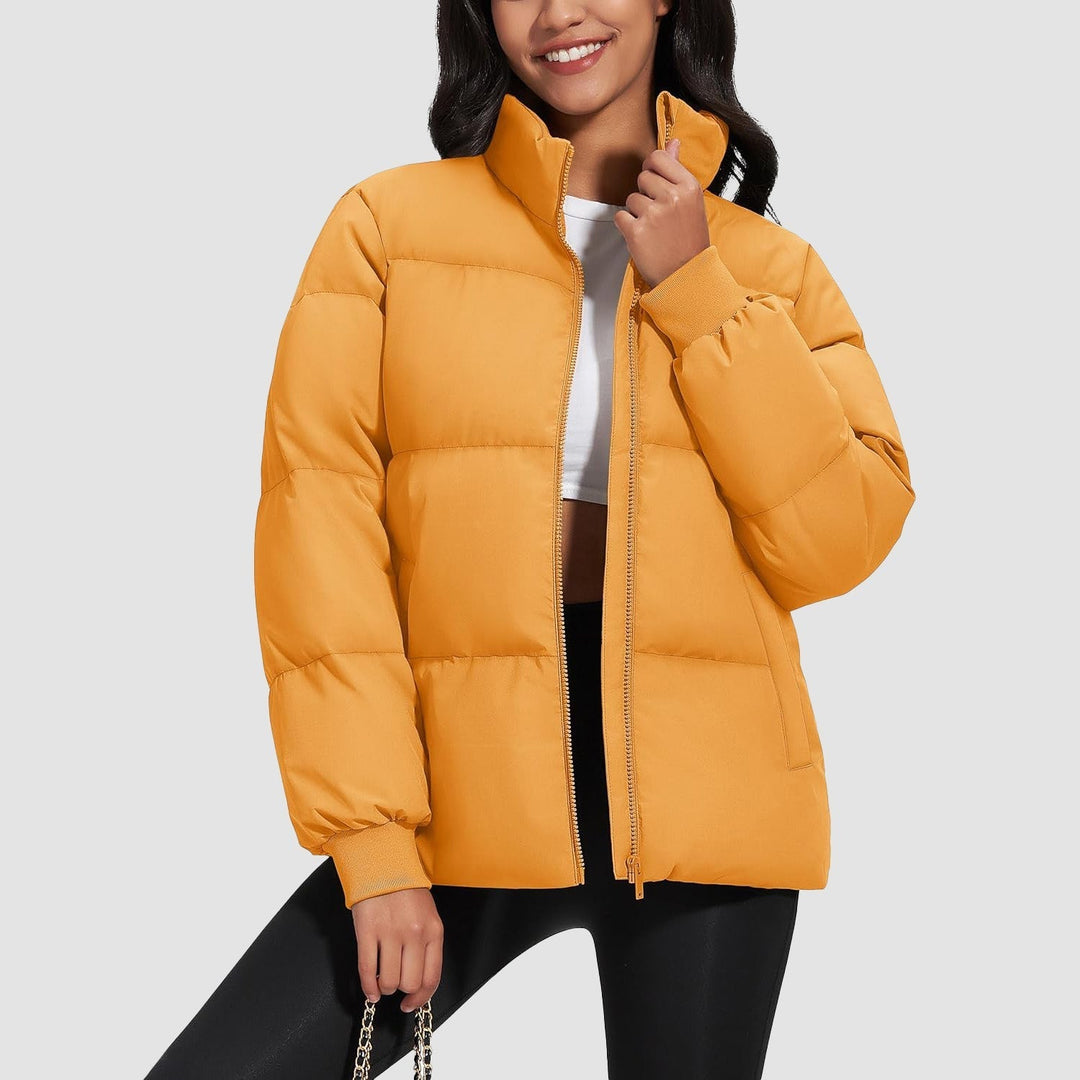 Woman walking in a park, wearing a black lightweight quilted winter coat, activewear