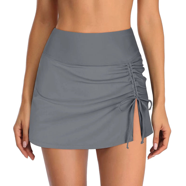 Woman enjoying water sports in Liv quick-dry side slit swim shorts. Comfortable & stylish for active days.