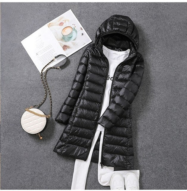 Warm women's long puffer winter coat. Essential outerwear with a detachable hood for ultimate cold weather comfort.