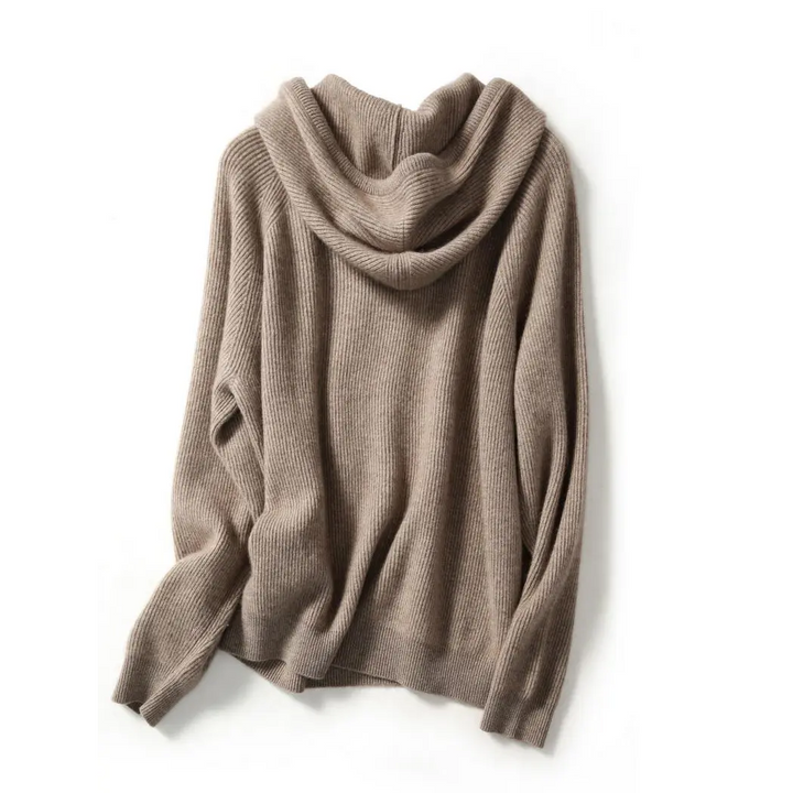 Woman on a couch, comfortably dressed in the cozy cashmere blend relaxed hoodie