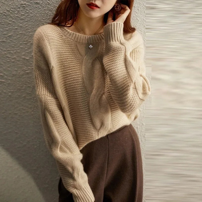 Soft women's cable knit sweater made from a cashmere blend, featuring a classic design for comfort and style