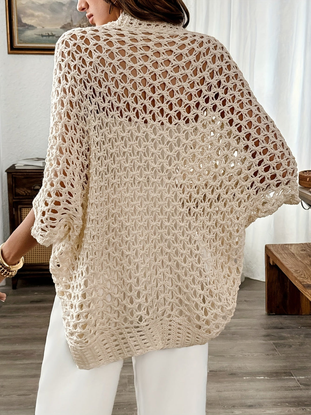 Elegant women's draped open knit cardigan with a relaxed, oversized fit, ideal for casual layering.