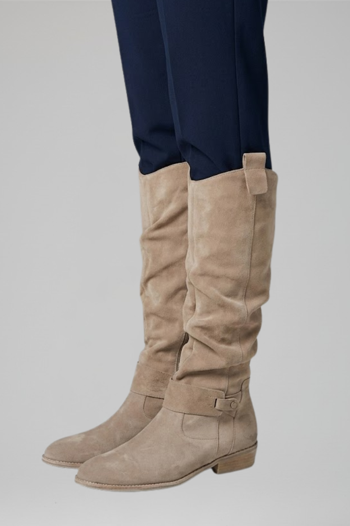 Supportive women's knee-high boots featuring orthopaedic design & sleek side zipper for fall & winter style.