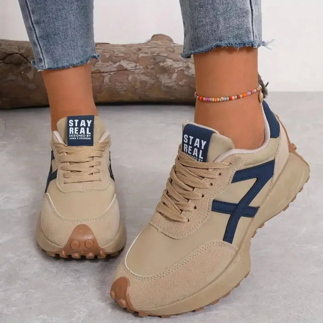Lace-up women's orthopedic sneakers with modern panel design, ideal for athletic casual and supportive walking.