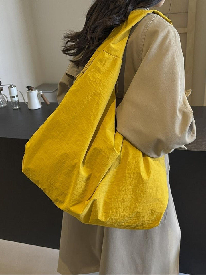 Front view of a women's oversized cotton canvas shoulder tote bag, simple design, practical for many occasions