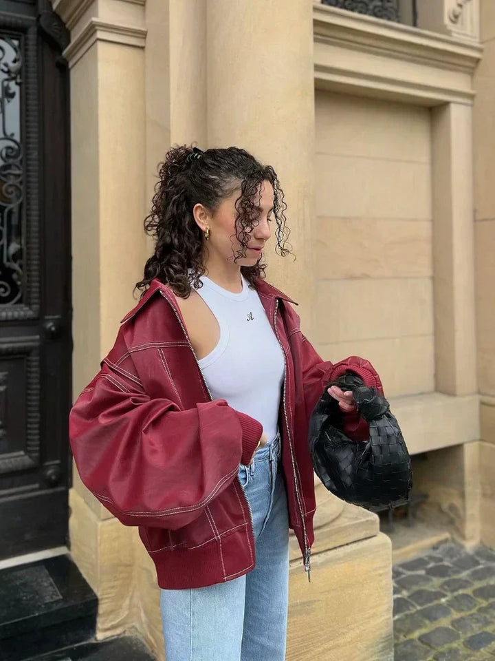 Stylish women's oversized faux leather bomber jacket in a rich brown, casual zip-up outerwear.