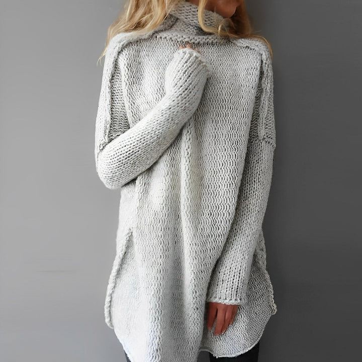Close-up of a women's oversized turtleneck knit pullover, highlighting the soft texture and relaxed fit