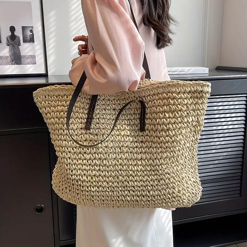 Durable woven straw travel bag for women, an oversized tote perfect for summer vacations.