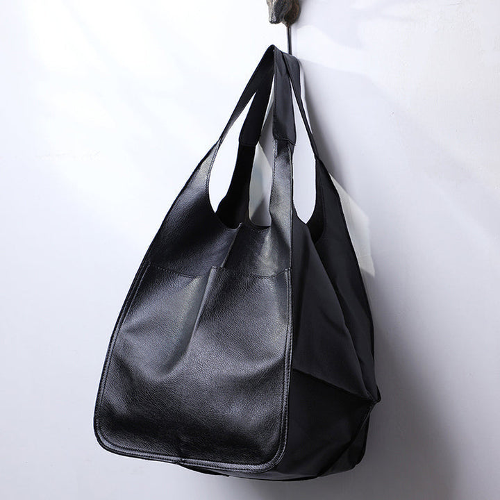 Classic women's oversized vintage leather shoulder bag, a durable travel and daily handbag.