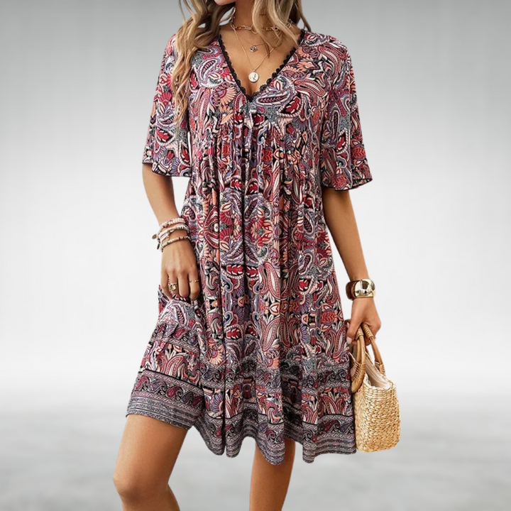 Casual women's short ruffle dress with a vibrant paisley print, lace trim, and V-neckline.