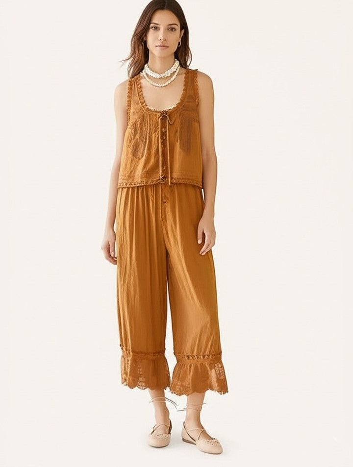 White cotton women's two-piece set with stylish lace trim details, perfect for vacation.