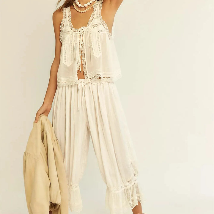 White women's two-piece cotton set with elegant lace trim, perfect for beachwear or loungewear.