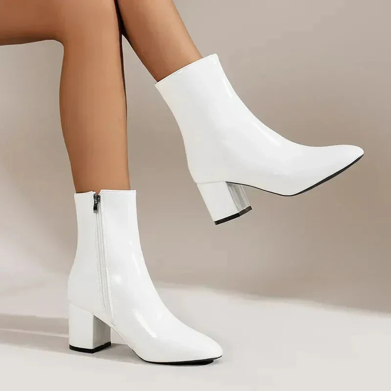 Women's premium black leather ankle boots with a comfortable block heel and chic almond toe, perfect for fall fashion.