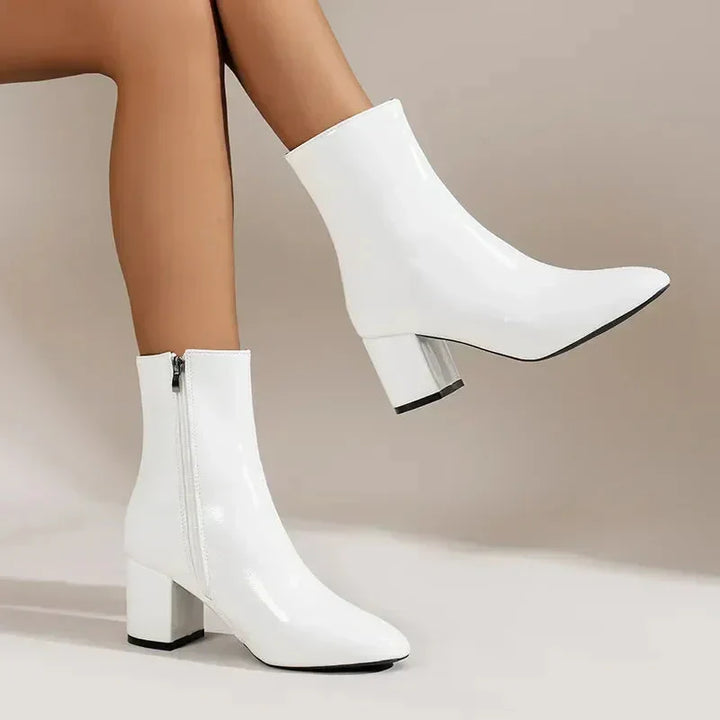 Women's premium black leather ankle boots with a comfortable block heel and chic almond toe, perfect for fall fashion.