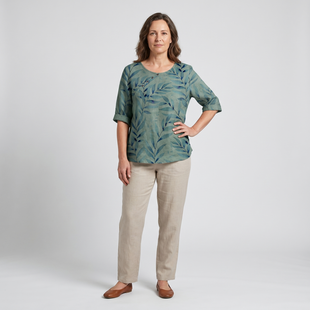 Stylish women's blouse with elegant leaf print and unique asymmetric button detail.