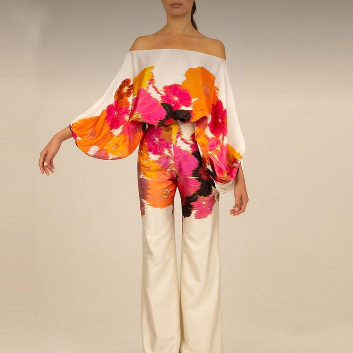 Fashionable women's printed co-ord set. One-shoulder top & wide-leg pants. Casual chic, comfortable vacation outfit.
