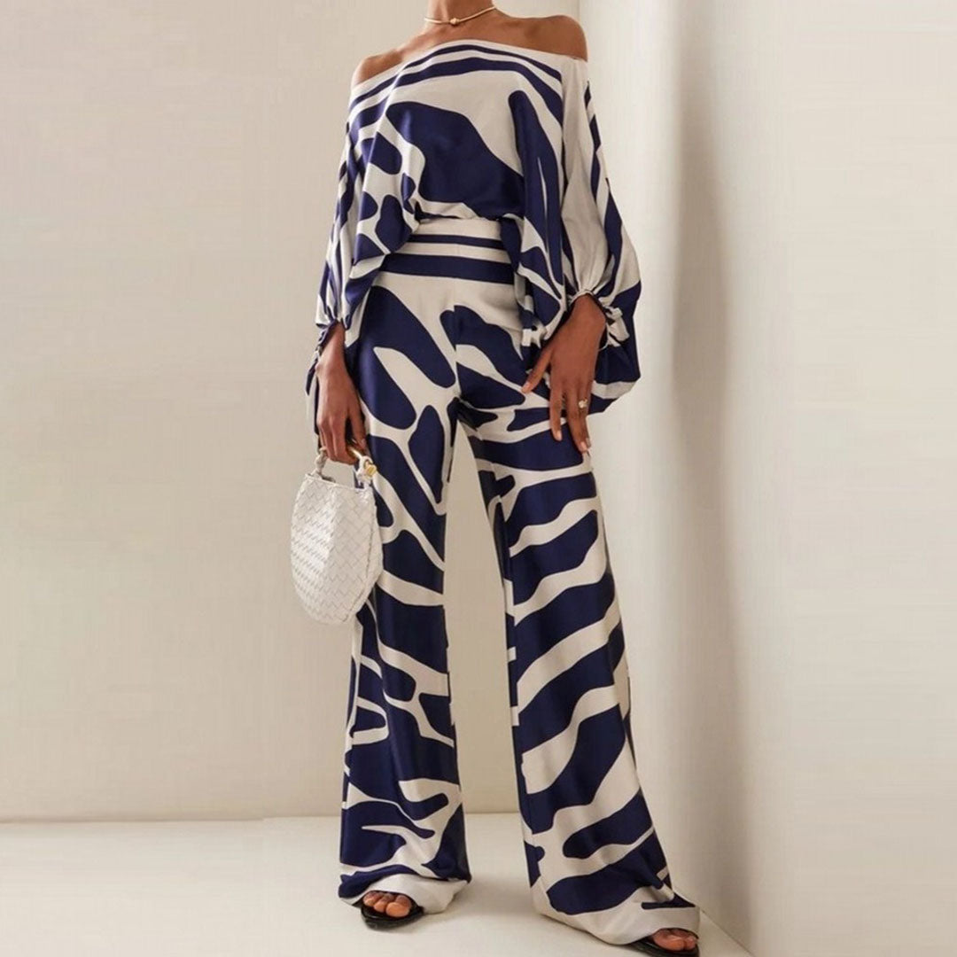 Stylish women's printed one-shoulder co-ord set. Includes a chic top and wide-leg pants for a complete outfit.
