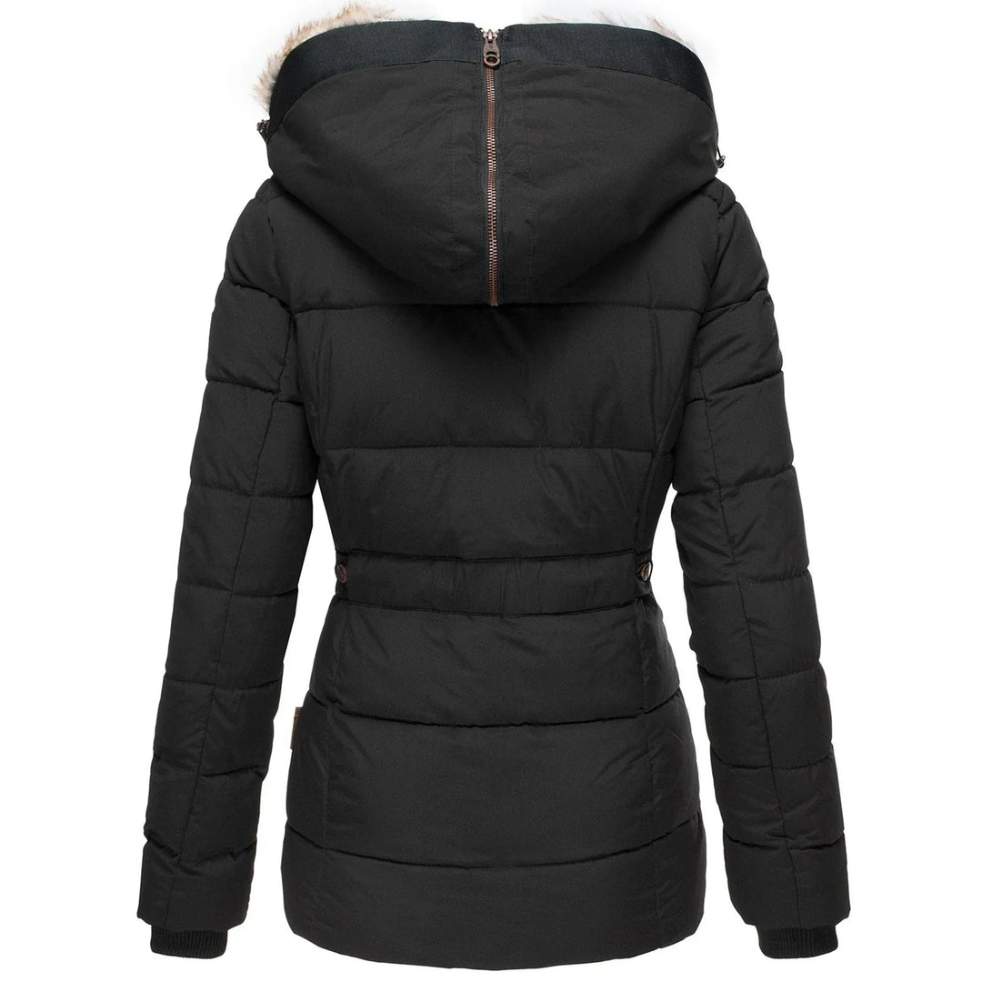 Stylish women's quilted outerwear: a puffer jacket with a fashionable faux fur hood for ultimate warmth.