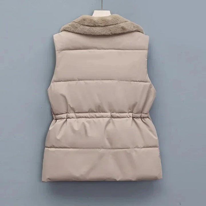 Back view of a women's quilted vest, highlighting its flattering fit and insulation