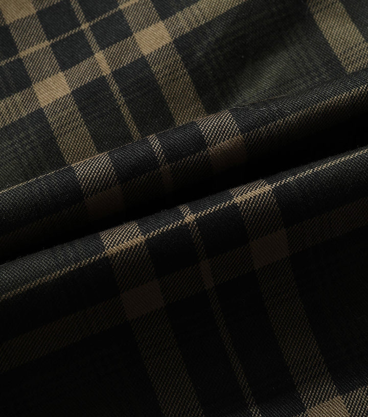 Folded women's plaid flannel jacket showcasing thick, warm fabric, essential outerwear.