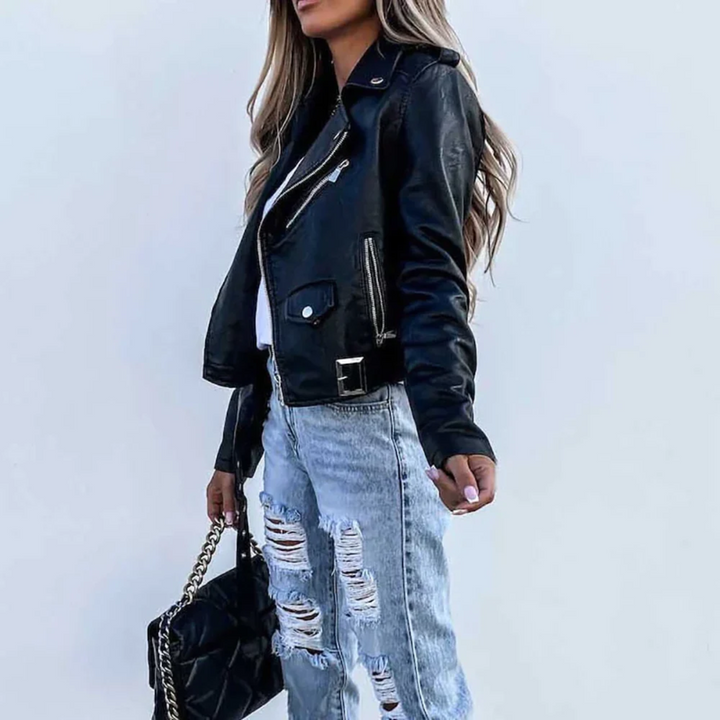 Close-up of the textured faux leather and silver zip detail on a versatile women's biker jacket.