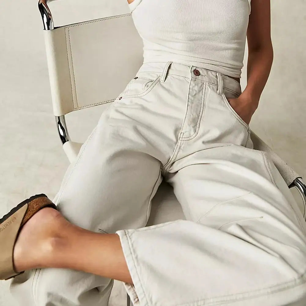 Detailed view of the button and zipper on women's relaxed barrel leg denim jeans, high quality