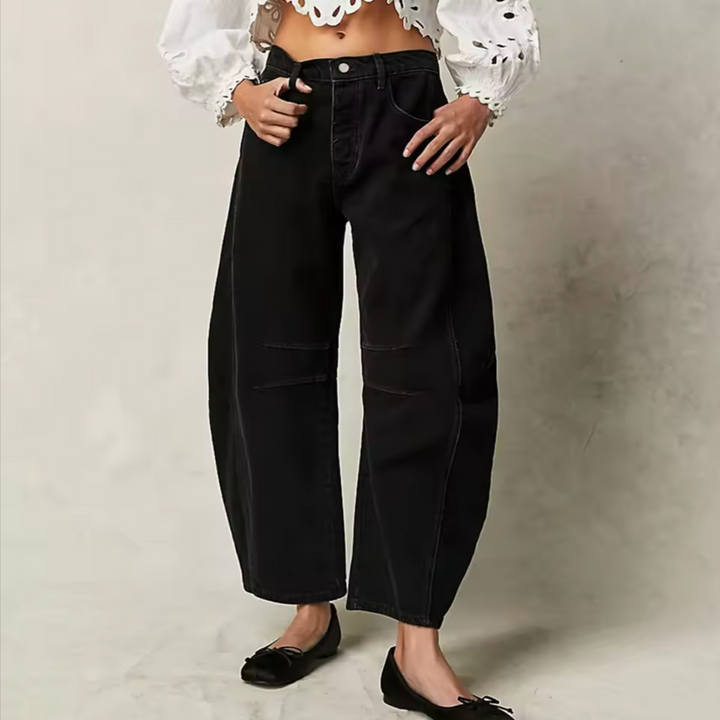 Close-up of barrel leg women's jeans, showing denim texture and relaxed fit for fashion