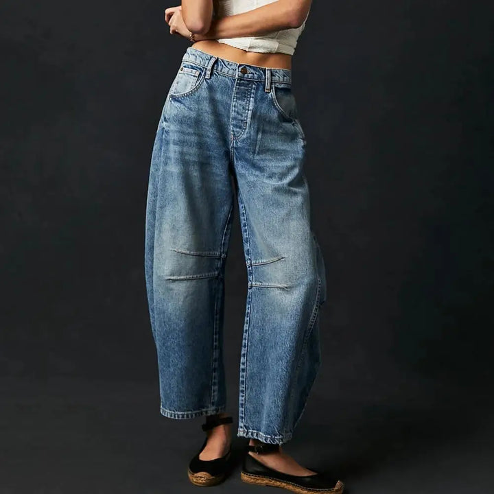 Model wearing women's barrel leg denim jeans, mid-rise, perfect for casual and comfortable style