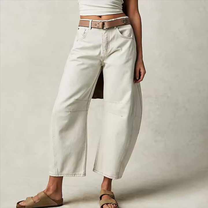 Detailed shot of barrel leg jean's stitching and cotton blend fabric, highlighting durabilit