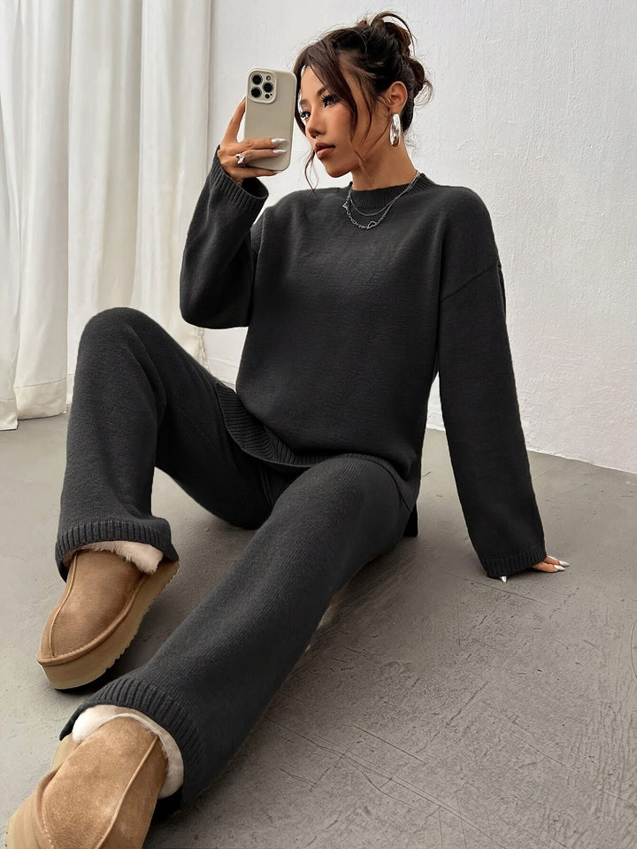 Woman posing in a black relaxed fit two-piece set, comfortable spring casual wear