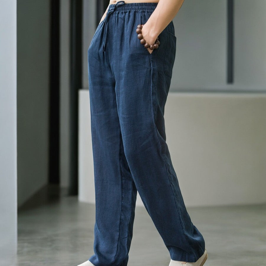 Stylish woman wearing comfortable relaxed fit linen pants with a casual top, outdoor setting