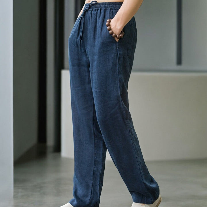Stylish woman wearing comfortable relaxed fit linen pants with a casual top, outdoor setting