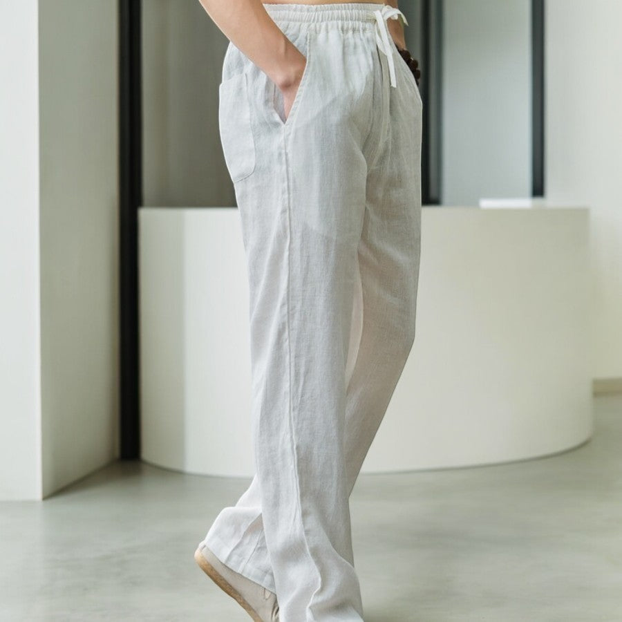 Full shot of women's relaxed fit linen pants in a light blue shade, showcasing flowy design