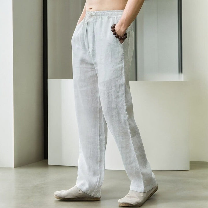 Pair of laid flat women's relaxed fit linen pants, highlighting the wide leg and soft texture