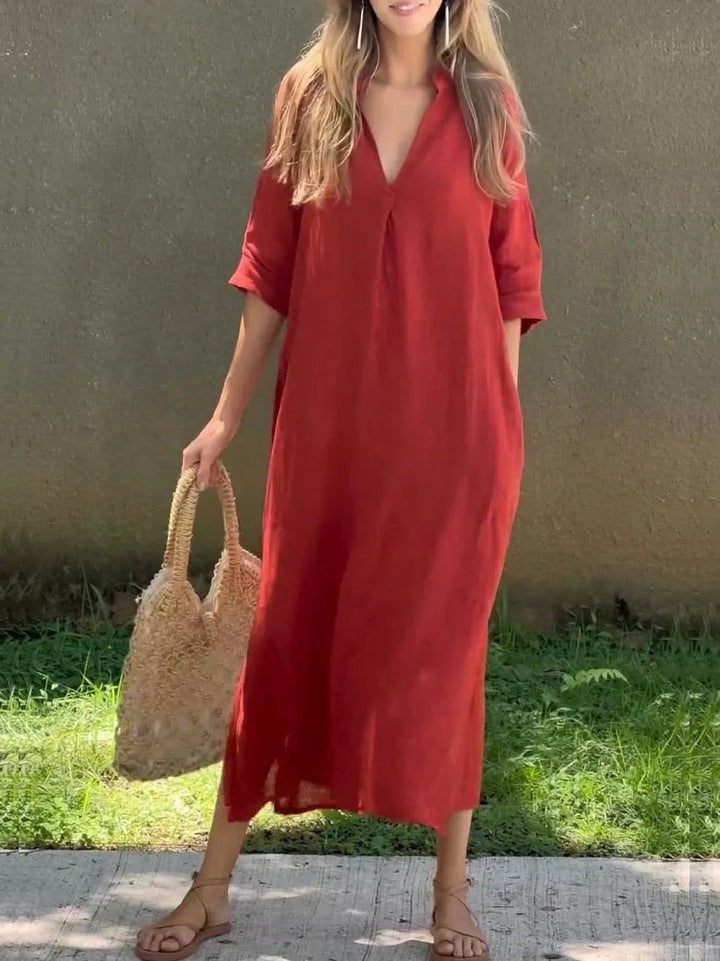 Flowy women's relaxed fit V-neck maxi dress for summer. Features 3/4 sleeves & elegant side slits for ease.
